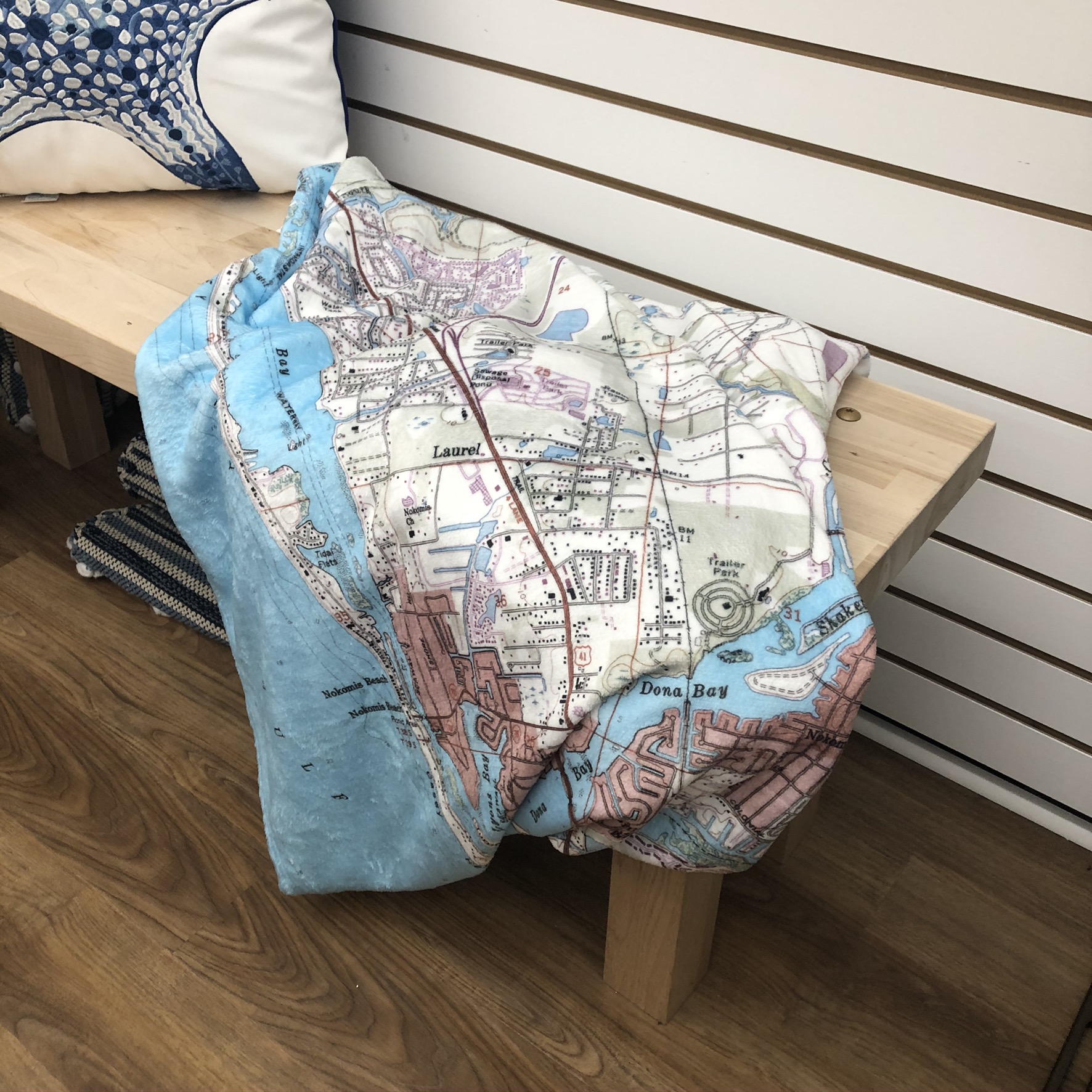 blanket with map of Venice Florida lying on on bench